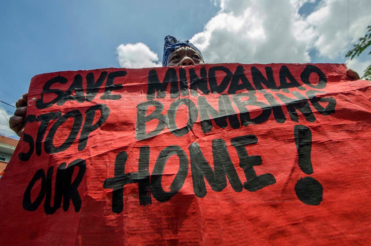 FIRST YEAR PROTEST. A Mindanao native holds an anti-martial law placard at a protest near Malacanang Palace on June 30, 2017, marking President Rodrigo Duterte's first year in office. Photo by Rob Reyes/Rappler   