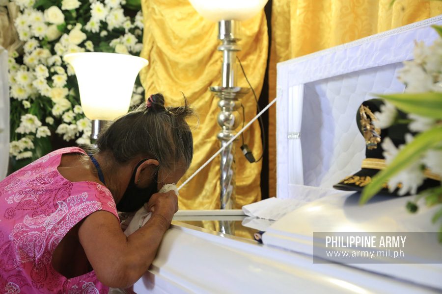 GRIEVING. A woman weeps at the casket of one of the 4 soldiers shot dead by police in Jolo, Sulu on June 29, 2020. Photo from the Philippine Army 