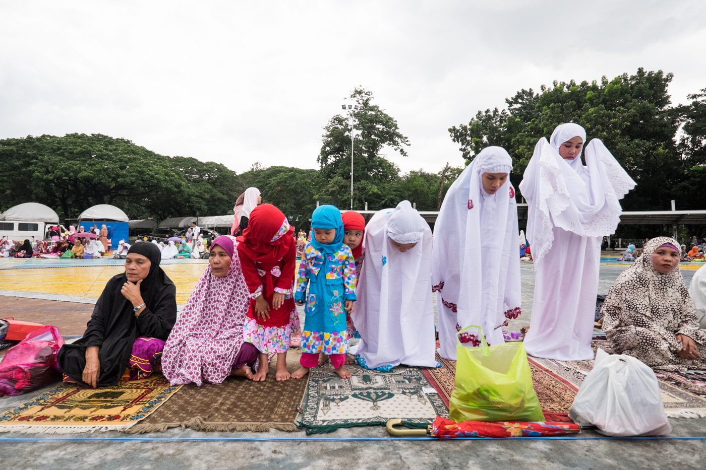 Muslim women recite a prayer before the start of the Eid Al-Fitr ceremony at the Quezon Memorial Center on July 17. 
