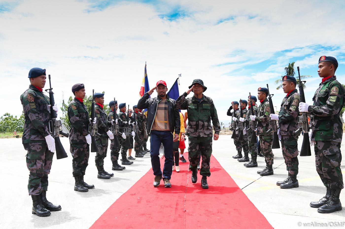 Manny Pacquiao walks to his airplane with a military escort. Photo by Wendell Alinea  