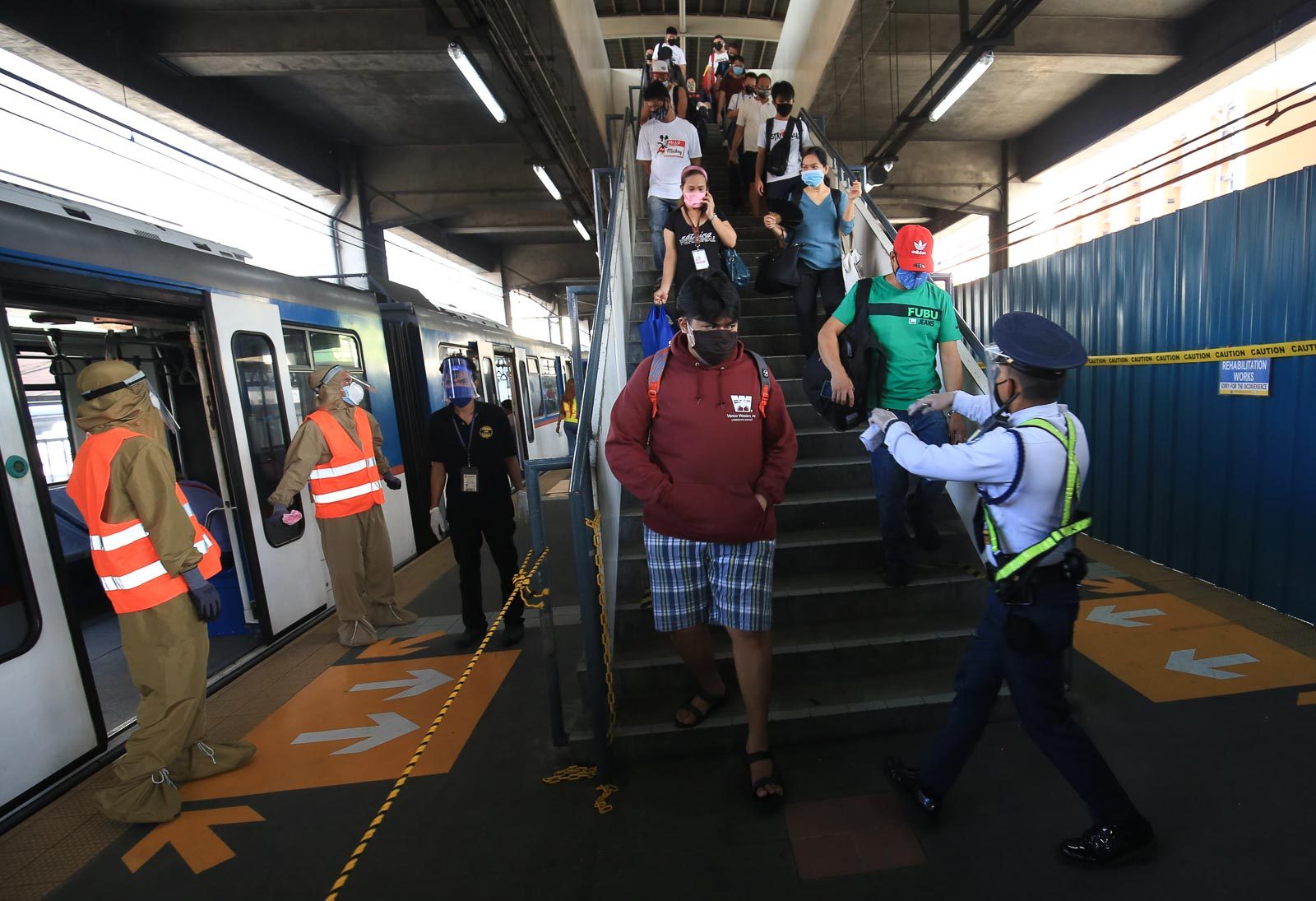 QUARANTINE MEASURES. Workers sanitize and disinfect seats and handrails before letting commuters in the coaches at the MRT3 Taft Station in Pasay City on June 1, 2020. Photo by Ben Nabong/Rappler 