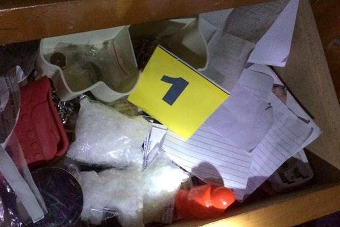 RAID. The November 1 raid on the Lumatao brothers' house yields a black flag appearing to be an ISIS emblem, 40 grams of suspected shabu, several explosive devices, live ammunition, bank documents, and monetary bills. Photo courtesy of PDEA Region XII 