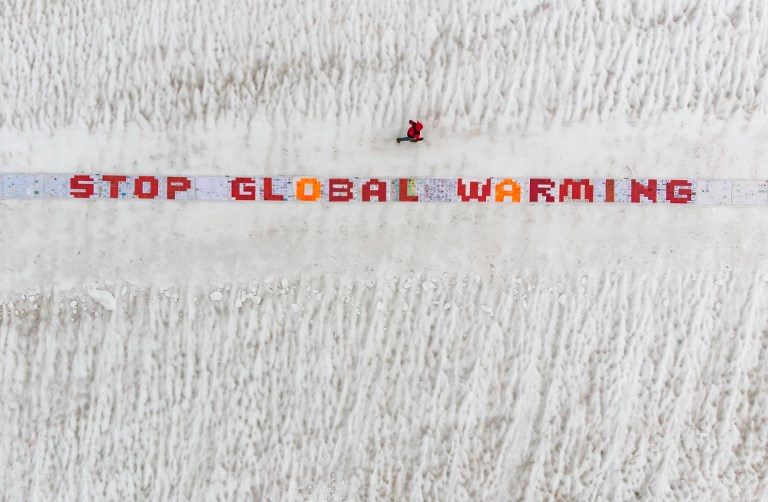 PREPARATION. A giant roll of more than 2500 laminated postcards is displayed for an exhibit test of an action against climate change attempt for a world record attempt on the largest postcard, in the Aletsch Glacier near the Jungfraujoch in the Swiss Alps on August 13, 2018. Photo by Fabrice Coffrini/AFP  