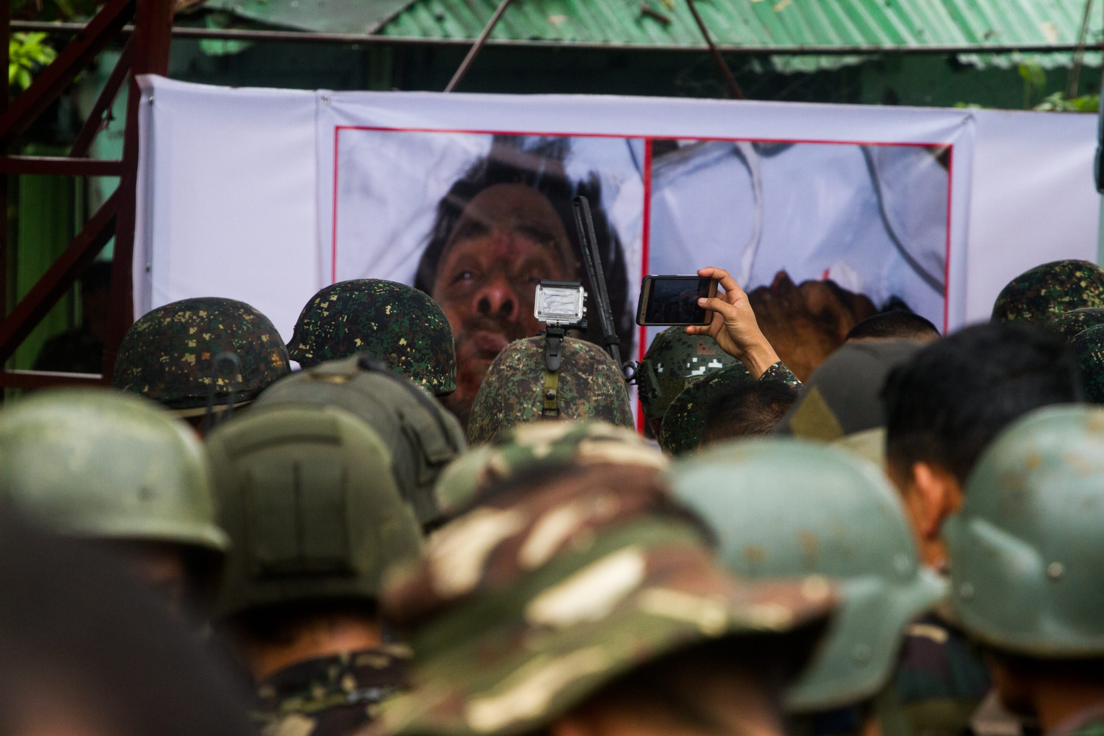 KILLED. Troops stare at enlarged photos of the dead bodies of terror leaders Isnilon Hapilon and Omar Maute. Photo by Bobby Lagsa/Rappler 