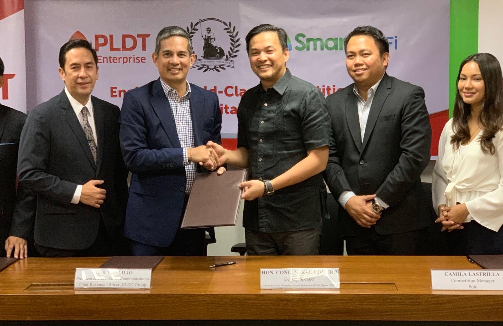 PARTNERSHIP. Deputy House Speaker and PNFPP founding director Mikee Romero (third from left) and PLDT chief revenue officer Al Panlilio (second from left) seal the agreement to install free Wi-Fi at the Miguel Romero Field during the SEA Games. Also shown (from left) are ePLDT president Jovy Hernandez, AirAsia executive Erick Arejola and polo competition manager Camila Lastrilla.  