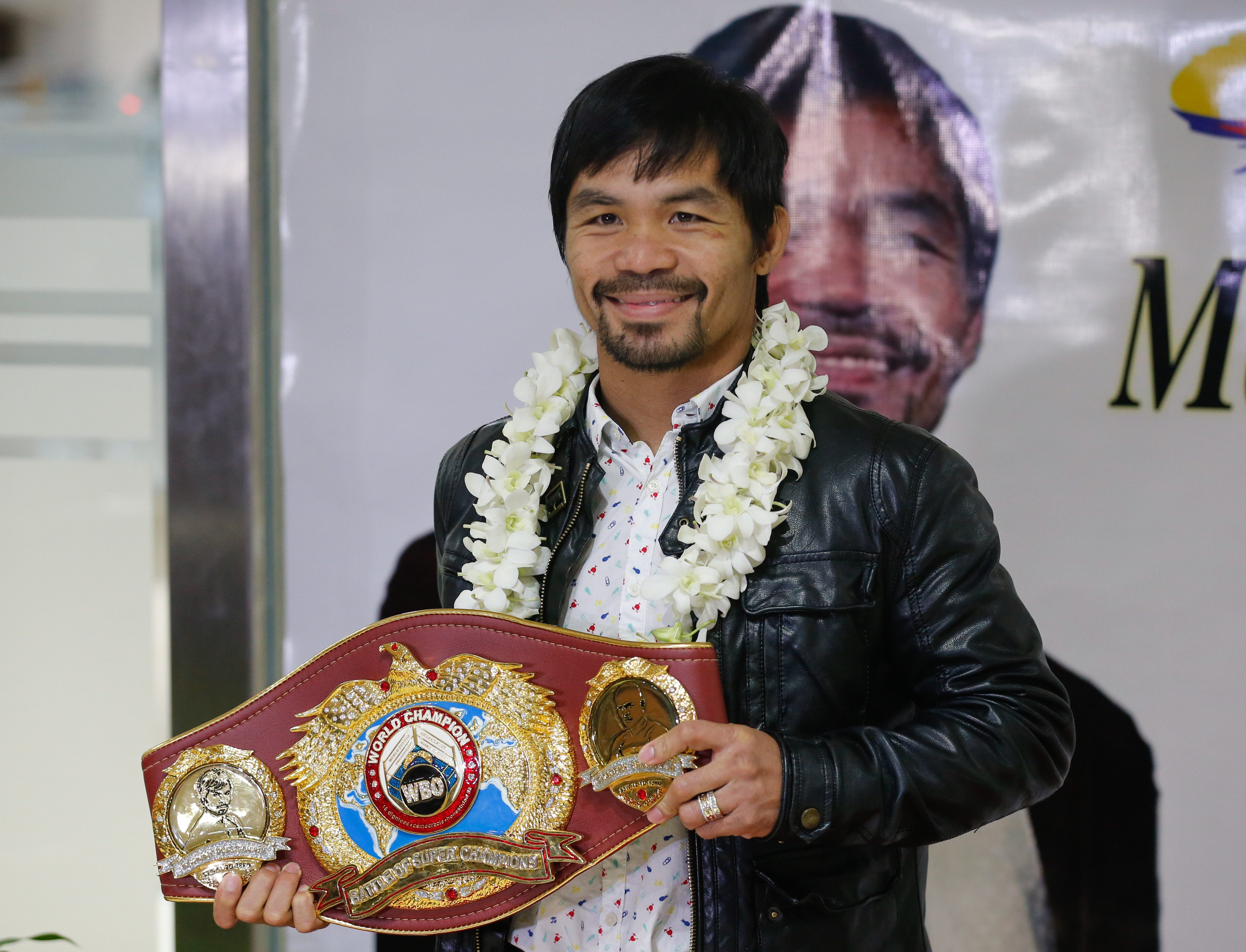 Filipino boxing icon Manny 'Pacman' Pacquiao holding his World Boxing Organization WBO International Welterweight Championship title poses for pictures upon his arrival at the Ninoy Aquino International Airport in Manila, Philippines, 14 April 2016. Philippine boxer Manny Pacquiao arrived in Manila after his unanimous win over US boxer Timothy Bradley in Las Vegas, USA in their World Boxing Organization WBO International Welterweight Championship title bout. Pacquiao declared his retirement from boxing following his match to focus on his family and political career. Pacquiao is running for Senator in the upcoming Philippine elections on 09 May. EPA/MARK R. CRISTINO 