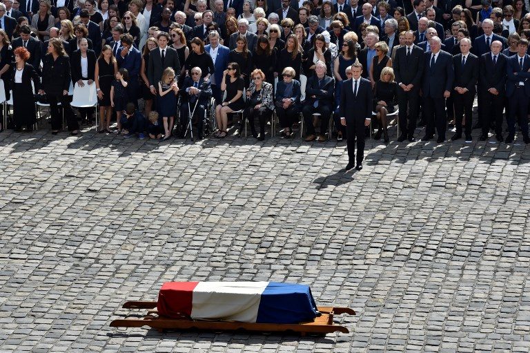 TRIBUTE. French President Emmanuel Macron, relatives of the deceased, and members of the government pay their respects by the coffin of French politician and Holocaust survivor Simone Veil during a tribute ceremony in the courtyard of the Invalides in Paris on July 5, 2017. Photo by Alain Jocard/AFP   
