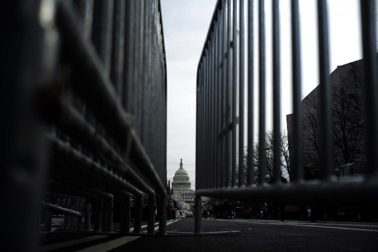 The US Capitol Building is seen through fences in Washington, DC, on January 19, 2017. Jewel Samad/AFP 