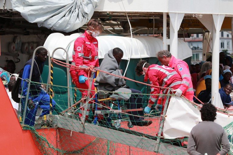 RESCUED. Members of the Italian Red Cross help a migrant to disembark from the Aquarius rescue Ship run by NGO S.O.S. Mediterranee and Medecins Sans Frontieres in the port of Salerno after a rescue operation in the Mediterranean sea, on May 26 2017. Carlo Hermann/AFP 