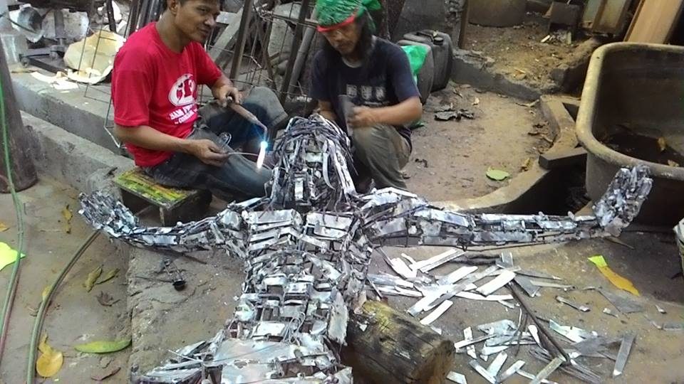 POOR'S CHAMPION. Two workers continue welding the metal sculpture of Jesus. Image courtesy of Kadamay  