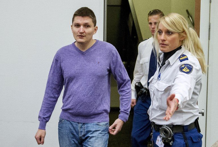 DRINKMAN. In this file photo, Russian defendant Vladimir Drinkman is escorted by police officers at the courthouse in The Hague, on January 13, 2015. Drinkman, is accused of helping to lead a prolific computer hacking ring, and in 2018, is sentenced to imprisonment in the US. Photo by Jerry Lampen/AFP 