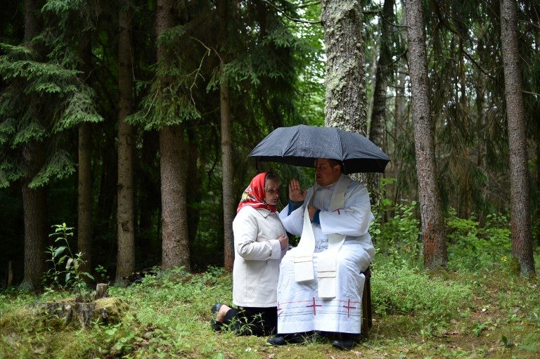 OUTDOOR CONFESSION BOOTH. A Catholic priest hears a confession during the annual celebration of "Icon of the Mother of Perpetual Help" in the forest near the village of Dubok, Minsk, on July 1, 2018. Photo by Sergei Gapon   