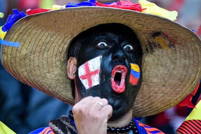 NEUTRAL. A football fan with his face painted with the flags of England and Colombia cheers before the Russia 2018 World Cup round of 16 football match between Colombia and England at the Spartak Stadium in Moscow on July 3, 2018. Photo by Alexander Nemenov/AFP  