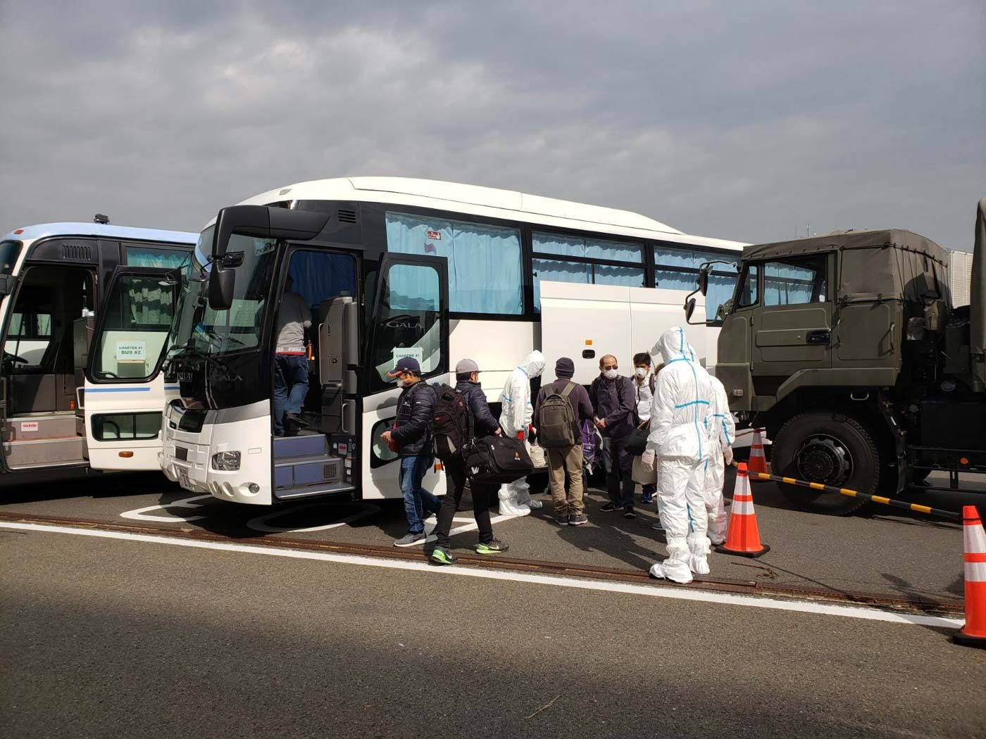 OFF TO THE AIRPORT. Filipinos from the cruise ship board buses to the Haneda Airport. They are assisted by teams from the DFA, DOH, and Japanese officials. Photo from the Department of Foreign Affairs 