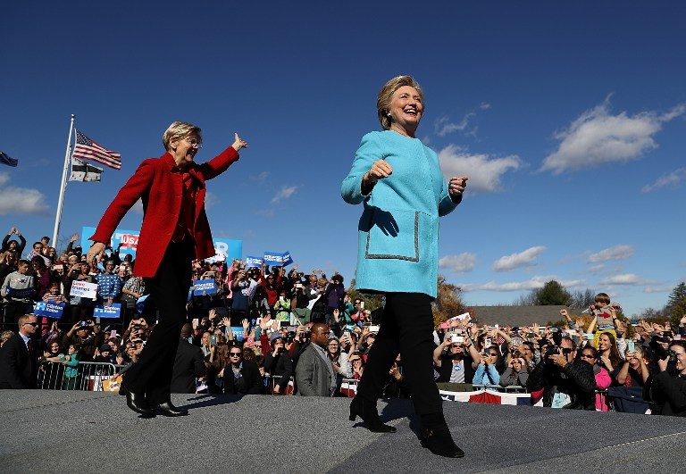 'NASTY WOMEN' Democratic presidential nominee former Secretary of State Hillary Clinton (R) and U.S. Sen. Elizabeth Warren (D-MA) greet supporters during a campaign rally at Saint Anselm College on October 24, 2016 in Manchester, New Hampshire. Justin Sullivan/Getty Images/AFP 
