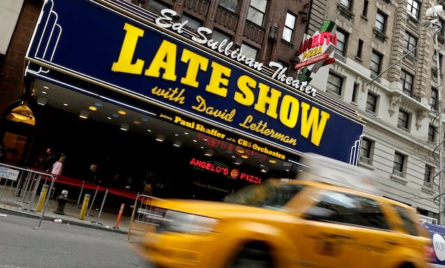 HOME OF LAUGHS. A taxi drives by the Ed Sullivan Theater where the Late Show with David Letterman is televised in New York, New York, USA, April 3, 2014. Peter Foley/EPA 