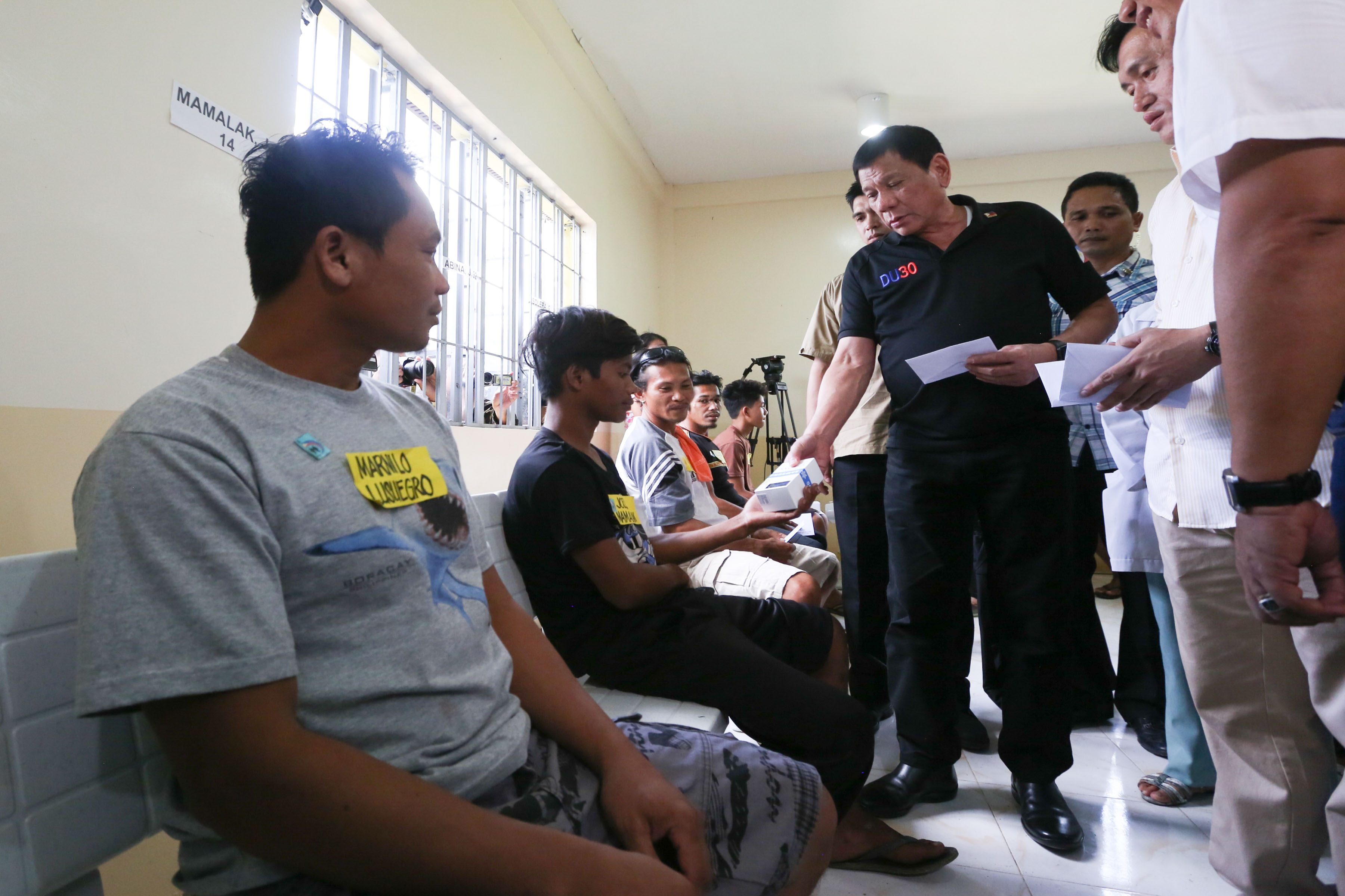 President Rodrigo Roa Duterte visits the victims of an IED explosion at Hilongos District Hospital on December 30,2016. TOTO LOZANO/Presidential Photo  