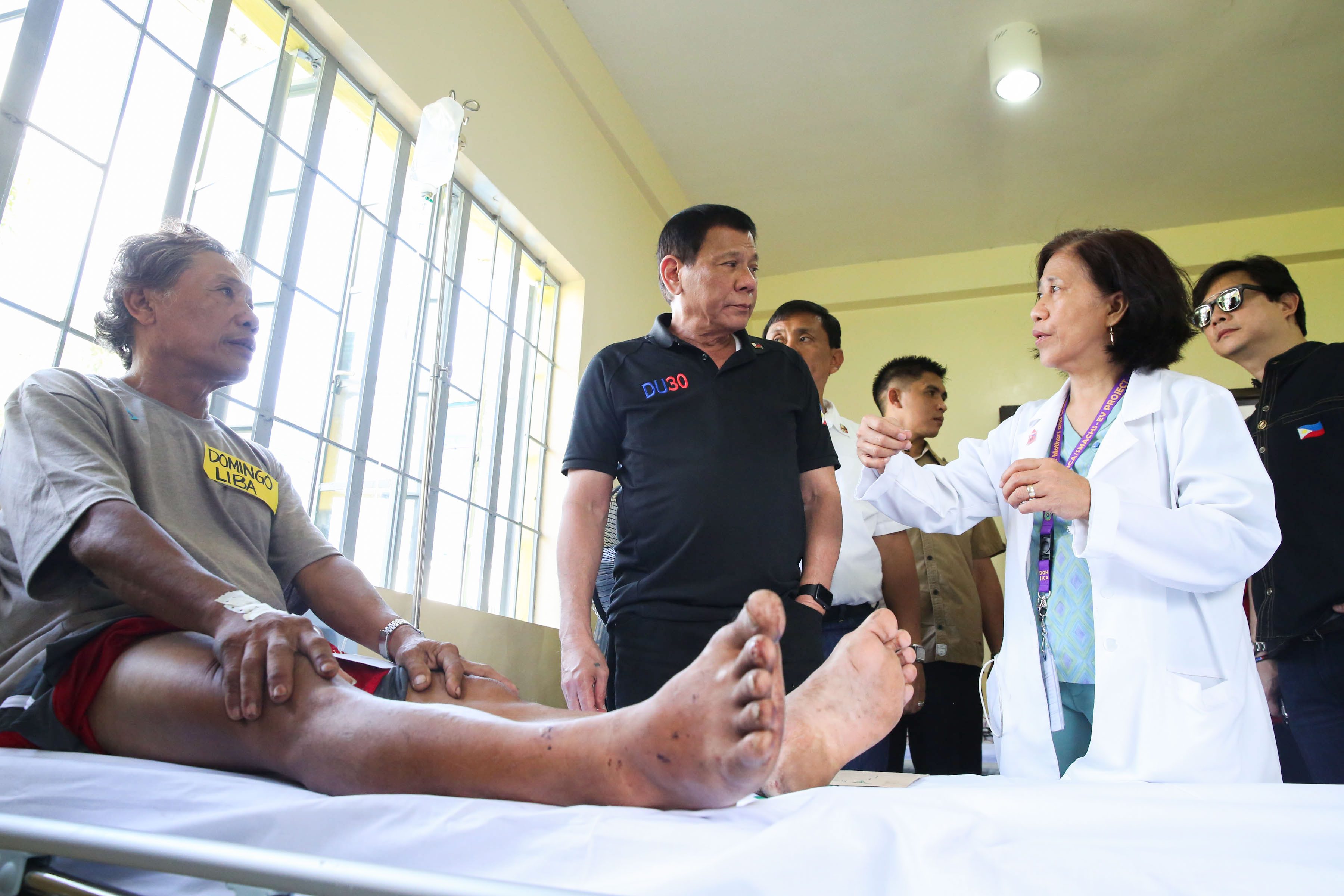 President Rodrigo Duterte listens to a resident doctor as he visits the the wounded victims of the recent explosion in Hilongos, Leyte on December 30. ALBERT ALCAIN/ Presidential Photo
 