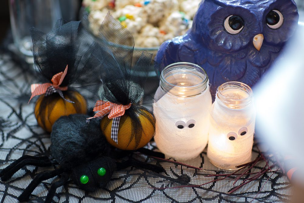 DECORATE! Gauze, watered down glue, googly eyes, and recycled olive jars add light to your Halloween tablescape when coupled with a candle. Photo by Jay Santos 