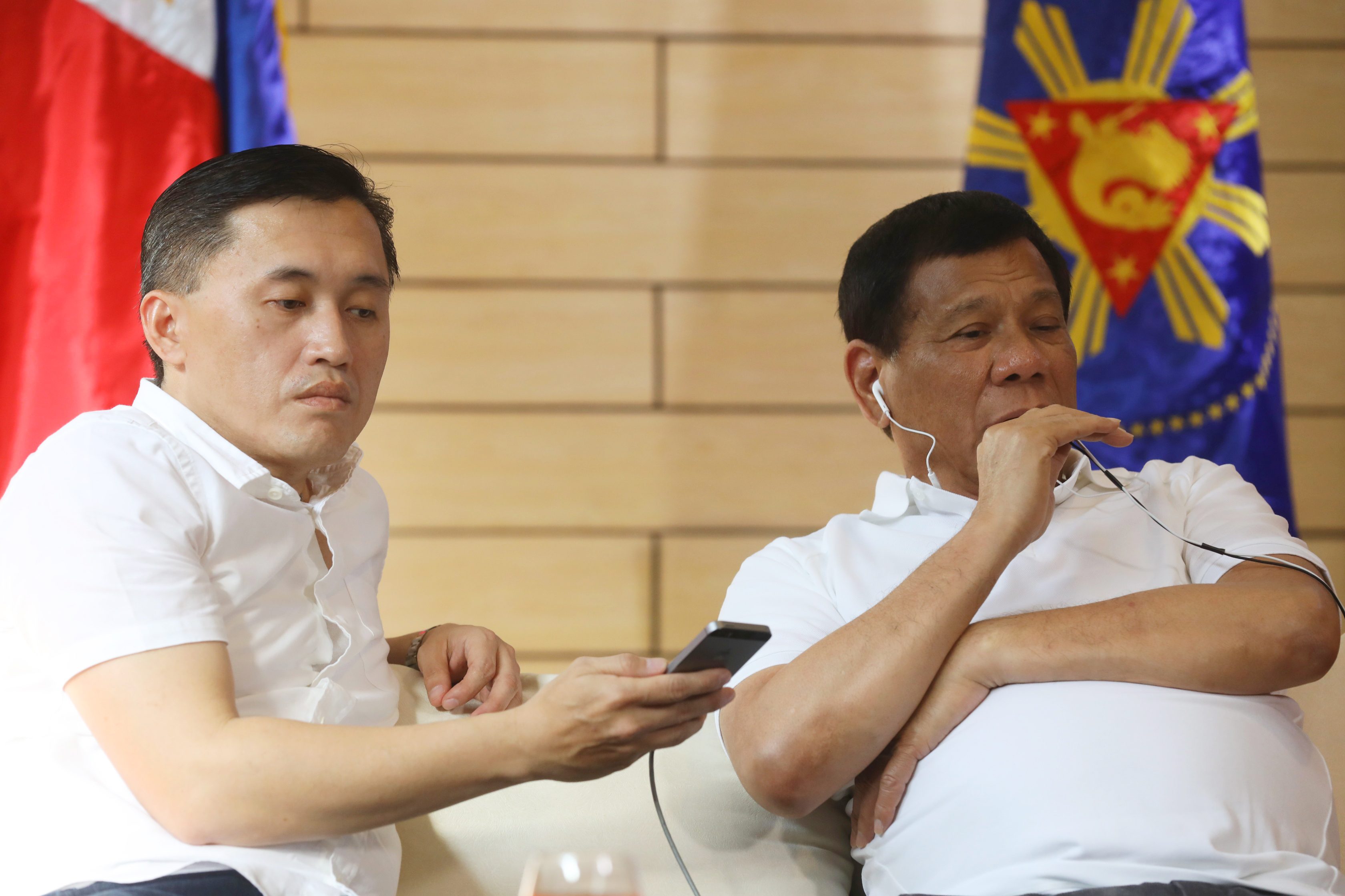 GATEWAY TO DUTERTE. Special Assistant to the President Bong Go helps President Duterte during his phone call with Chinese leader Xi Jinping. Presidential photo 