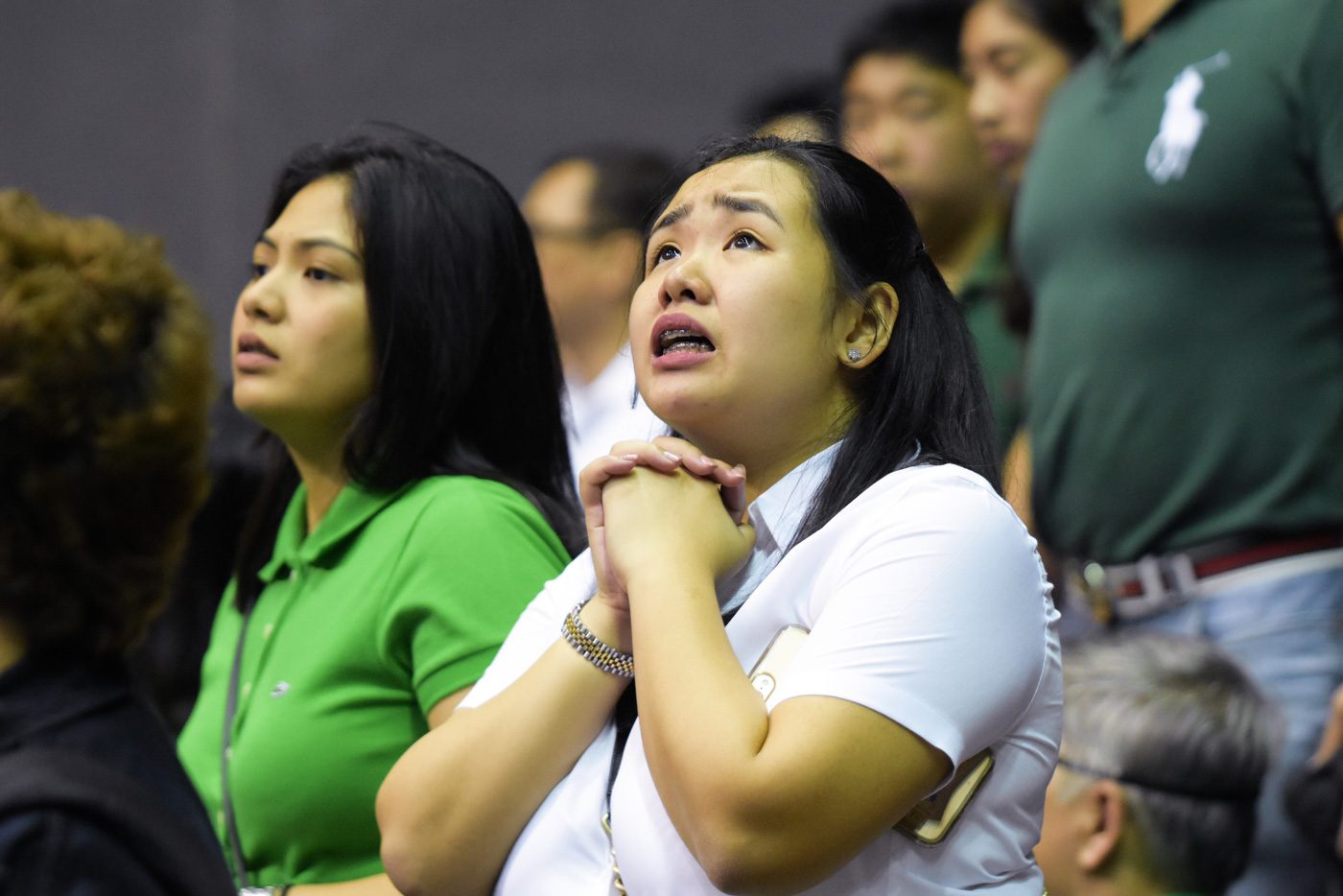 PRAYERS. The Green Archers were behind the Blue Eagles for most of the game, leading to a jittery DLSU crowd. Photo by Alecs Ongcal/Rappler  