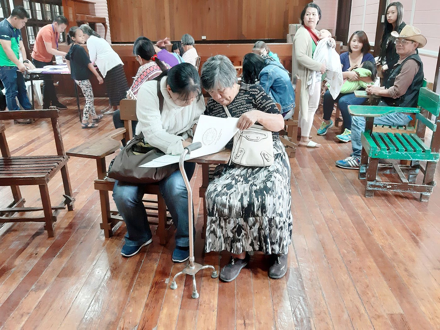BAGUIO CITY. Visually-impaired individuals cast their vote with the help of their relatives on Monday, May 13. Photo by Mau Victa/Rappler 