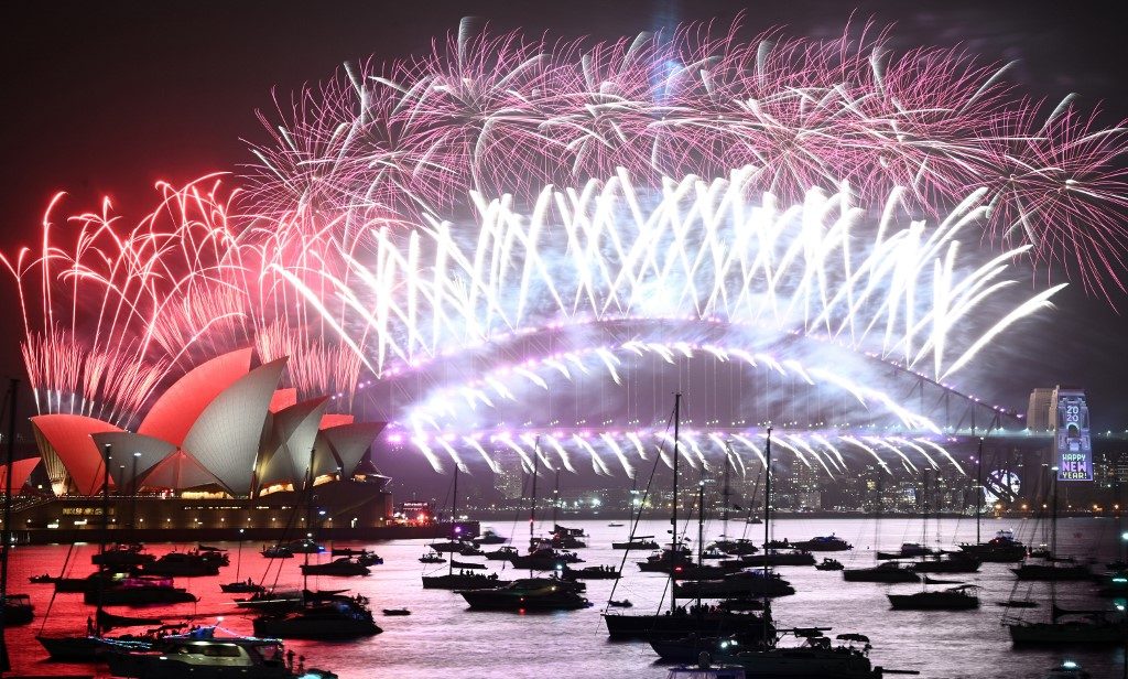 HELLO, 2020. New Year's Eve fireworks erupt over Sydney's iconic Harbor Bridge and Opera House during the fireworks show on January 1, 2020. Photo by Peter Parks/AFP 
