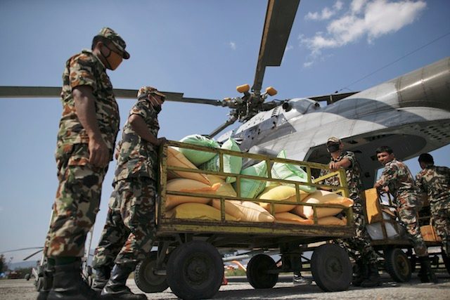 AID RUN. Nepali soldiers load relief goods onto an Indian helicopter at the airport in Kathmandu, Nepal, May 4, 2015. Diego Azubel/EPA 