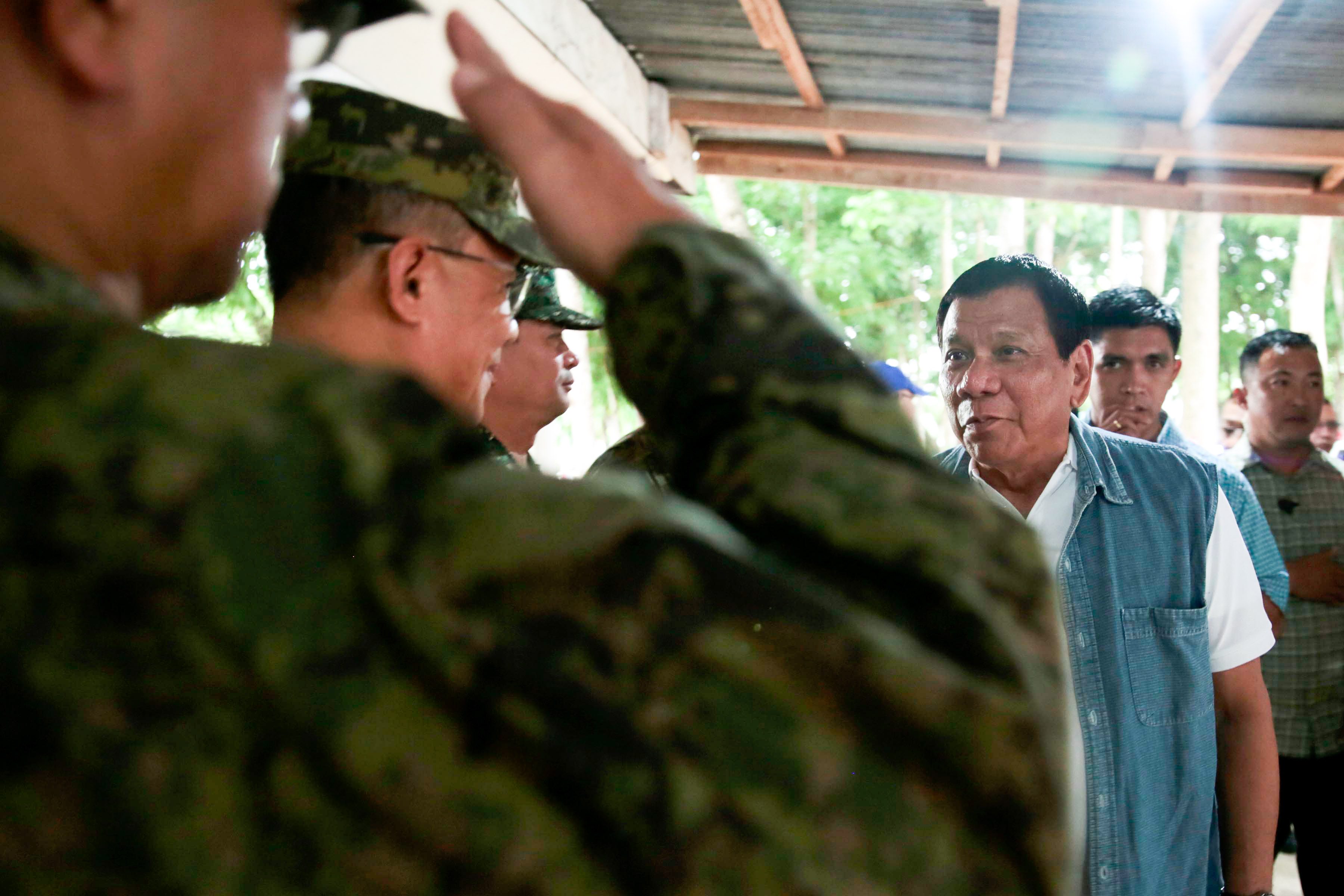 'RISE, MARAWI.' President Rodrigo Duterte is welcomed by military officials as he visits families displaced by the Marawi crisis. Malacañang file photo 