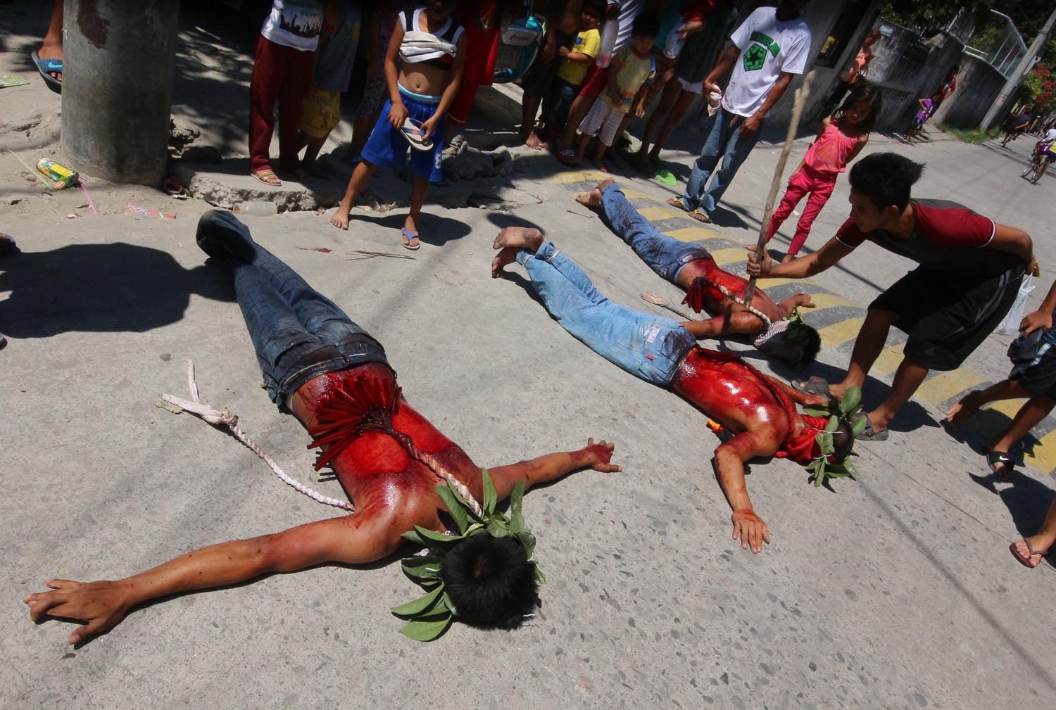 OFFERING. A man whips a devotee lying on the ground. Photo by Darren Langit 