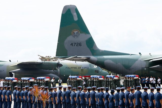 Members of elite Police Special Action Force carry the remains of forty two of their forty four comrades from three C-130 military planes that arrived at the Villamor Air Base on January 29, 2015. Photo by Dennis Sabangan/EPA 