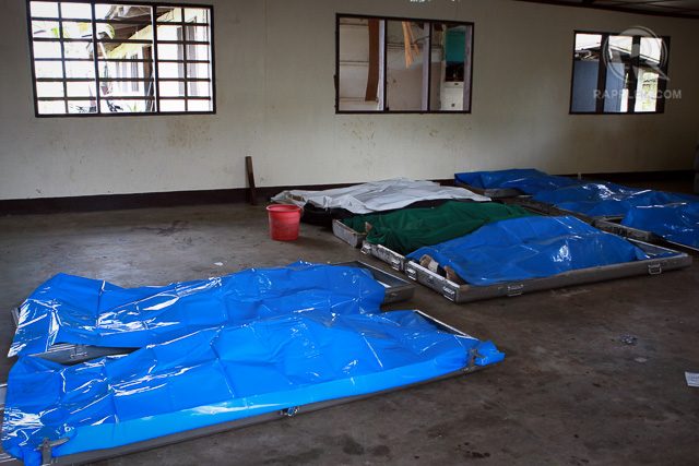 Bodies of slain policemen killed in intense fighting with Moro rebels coddling Malaysian terror bomb expert in Mamasapano, Maguindanao lies on the ground of morgue inside the 6th Division camp in Datu Odin Sinsuat town in Maguindanao, January 27, 2014. 