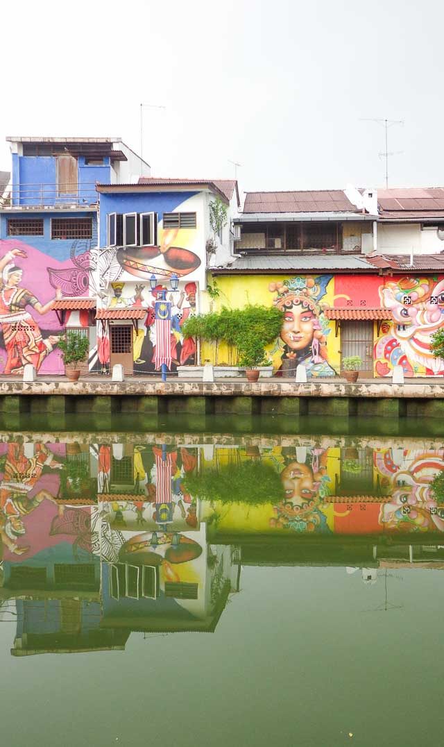 REFLECTION. Many of the old houses along the river have beautiful murals depicting Malaysian culture and diversity 