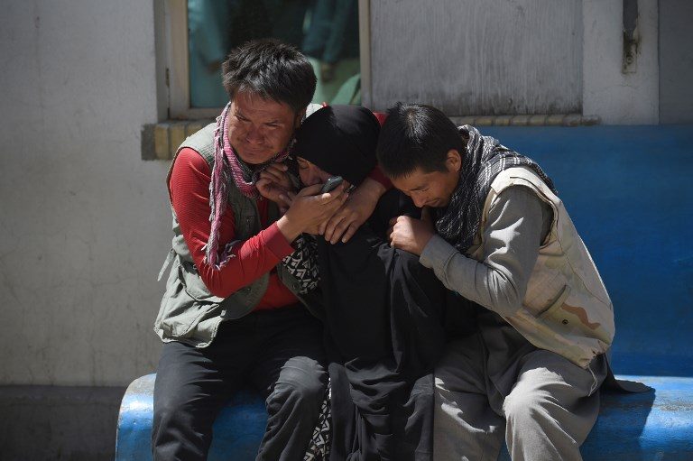 SUICIDE ATTACK. Afghan residents weep for their relatives following a suicide bombing attack at the Isteqlal Hospital in Kabul on April 22, 2018. Photo by Wakil Kohsar/AFP  