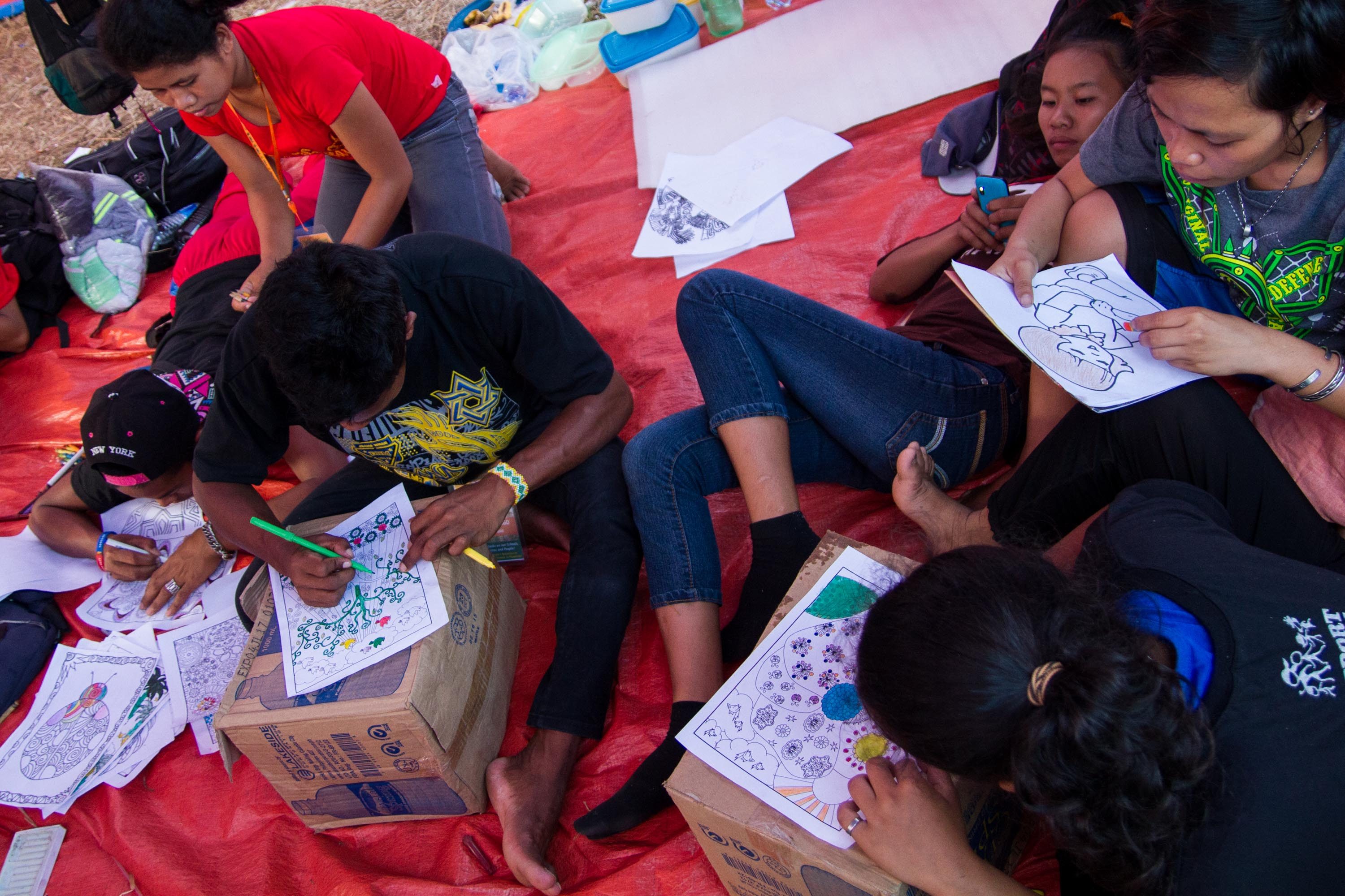 LEARNING. Lumad students learn to draw and color during the Manilakbayan camp in UP Diliman as part of their intergration program. 