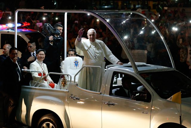 WHAT FILIPINOS SAW. On his way to the Apostolic Nunciature for his first night in the Philippines, Pope Francis riding on his 'popemobile' waves to well-wishers along a street in Manila on January 15, 2015.  