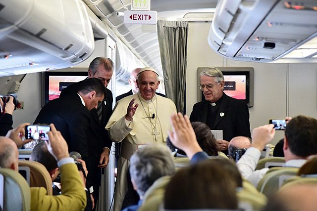 Pope Francis attends a press conference aboard a plane during his trip to the Philippines on January 15, 2015. Photo by Giuseppe/AFP