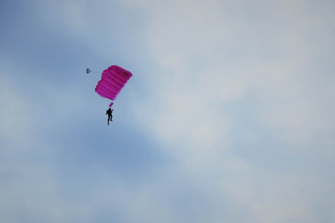AIRBORNE. Fr. Mario Beltran Patangan in the air on his pink parachute. Photo by Gualberto Laput 