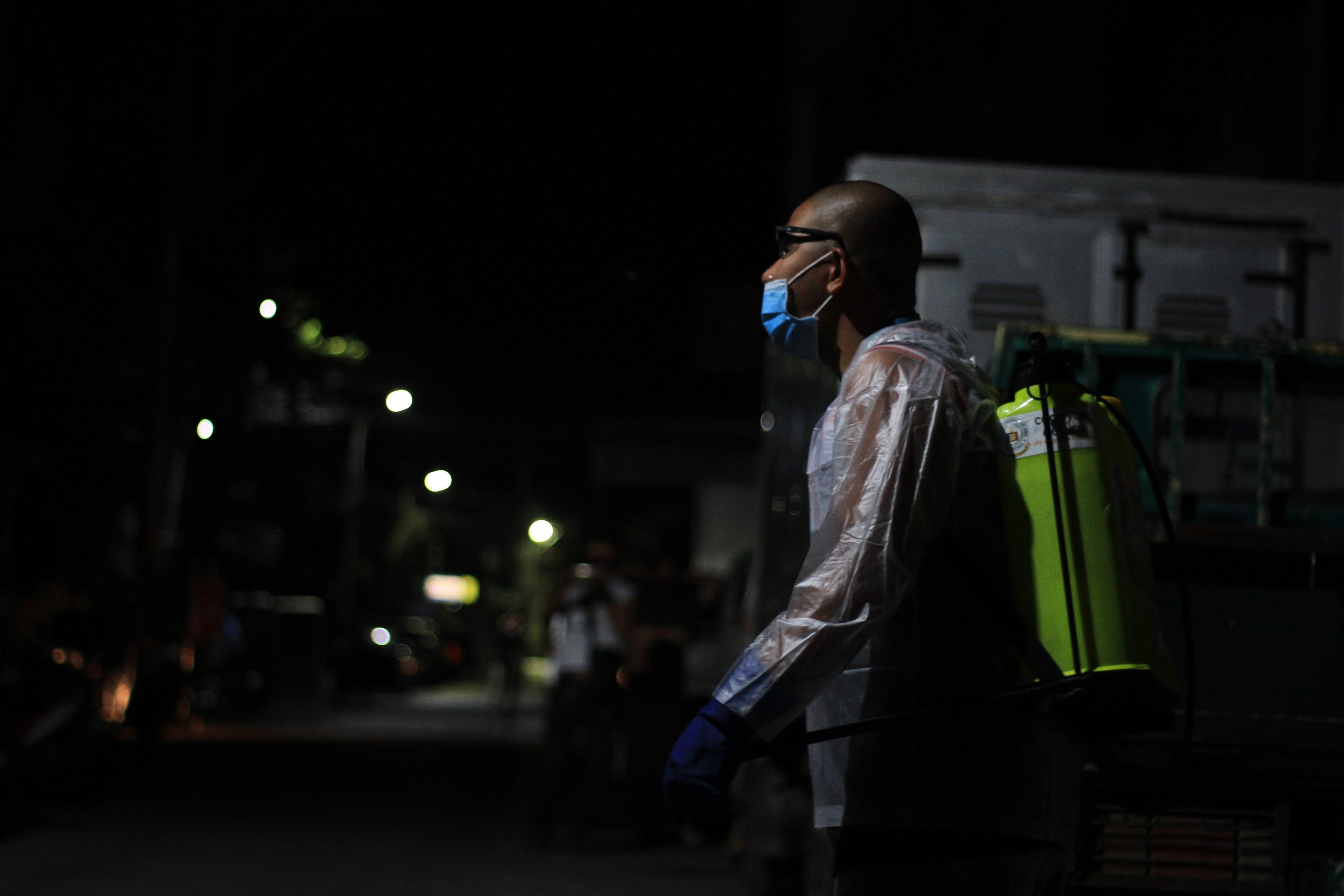 NIGHT PATROL. A City government worker disinfects one of the barangays in Cagayan de Oro City. Photo by Bobby Lagsa/Rappler  
