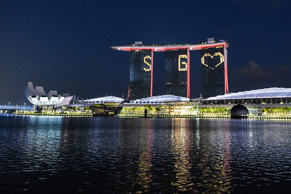 'SG UNITED.' The letters and symbol SG Love light the facade of Marina Bay Sands on April 10, 2020, as message of hope as Singapore battles COVID-19. Photo by Roslan Rahman/AFP 