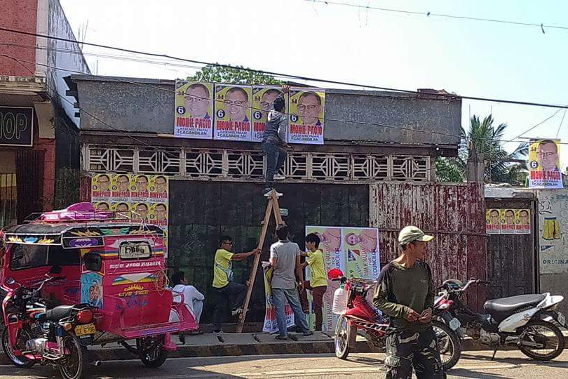 PASTING TIME. Supporters of local candidates fill up spaces with posters around Basilan as the campaign period for local posts kicks off on March 26, 2016. Photo by Richard Falcatan/Rappler  