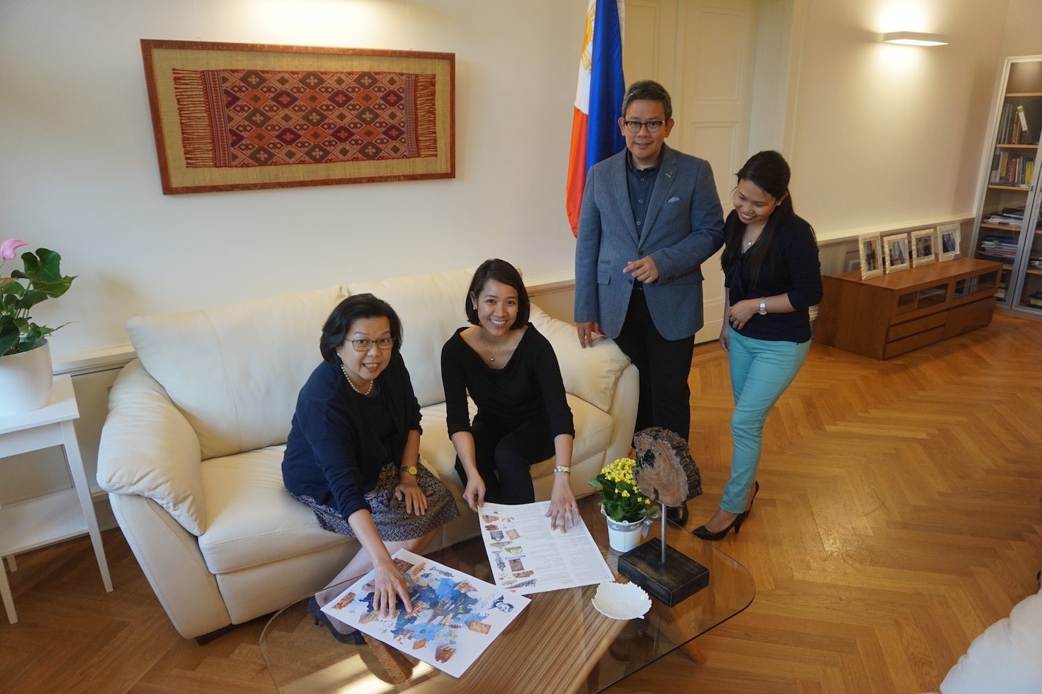 EMBASSY TEAM. Ambassador Sta. Maria-Thomeczek (L) and Consul Adrian Cruz (2nd from R) with staff members of the Philippine Embassy in Berlin finalizing some details on the map. Photo by Carol Ramoran 