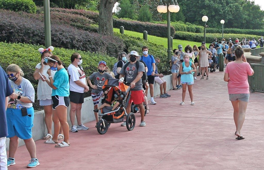 REOPENING. Guests wearing protective masks wait to pick up their tickets at the Magic Kingdom theme park at Walt Disney World on the first day of reopening, in Orlando, Florida, on July 11, 2020. Photo by Gregg Newton/AFP 