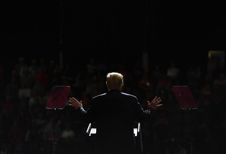 CHIAROSCURO. US President Donald Trump speaks during a rally at WesBanco Arena in Wheeling, West Virginia on September 29, 2018. Photo by Mandel Ngan/AFP   