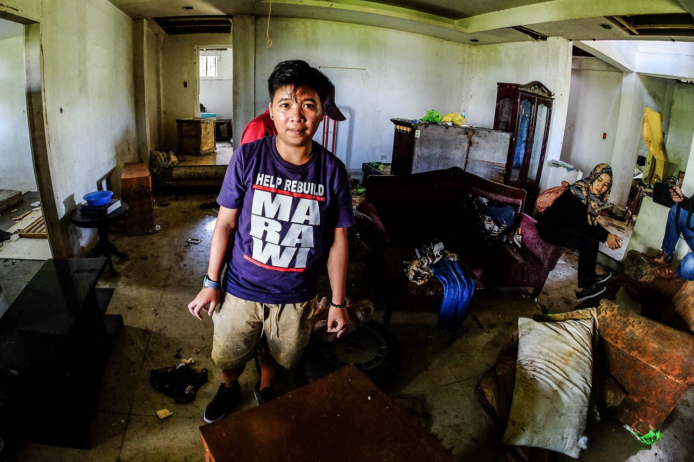 HELP REBUILD MARAWI. A family friend of the Alonto-Tamano family wears her Marawi shirt as she helps salvage what was left of the family possessions.  