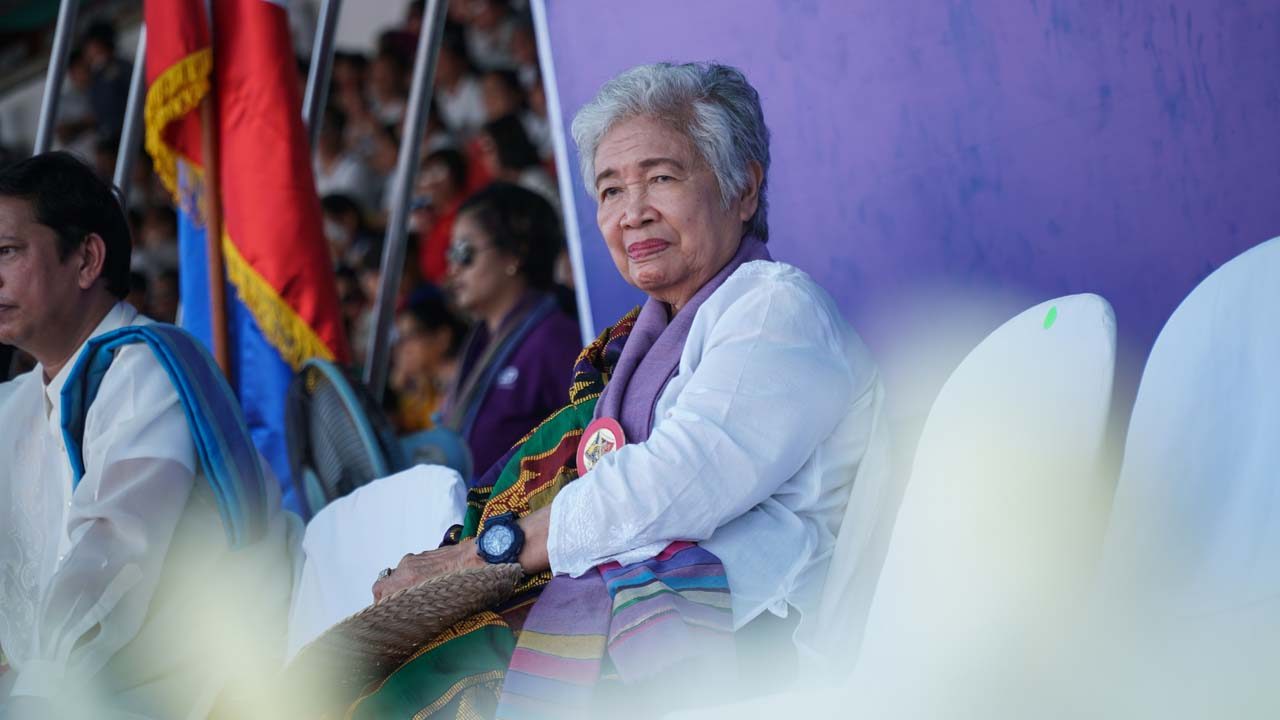 PROUD. Education Department Secretary Leonor Briones watches as different regions take turns in performing at the Binirayan Sports Complex.  