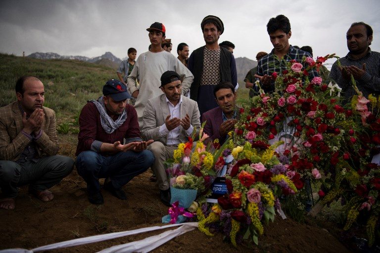FINAL RESPECT. Friends and relatives of Agence France Presse Afghanistan Chief Photographer Shah Marai Faizi gather at his burial in Gul Dara, Kabul on April 30, 2018. Photo by Andrew Quilty/AFP/Pool  