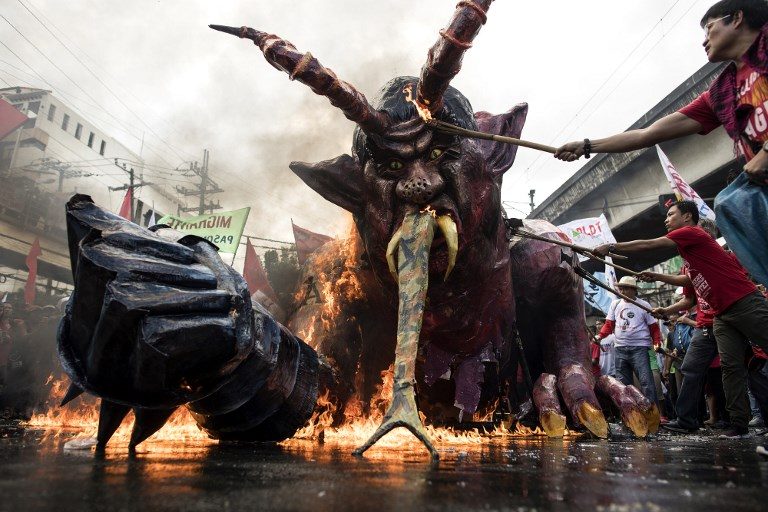 'DUTERTEMONYO'. Workers belonging to the militant Kilusang Mayo Uno burn a giant effigy of President Rodrigo Duterte during a May Day rally in Mendiola, Manila on May 1, 2018. Photo by Noel Celis/AFP  