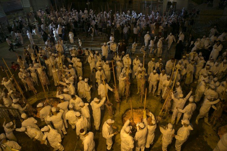 PASSOVER SACRIFICE. Samaritans take part in the traditional Passover sacrifice ceremony at Mount Gerizim near the northern West Bank city of Nablus on April 29, 2018. Photo by Jaafar Ashtiyeh/AFP  