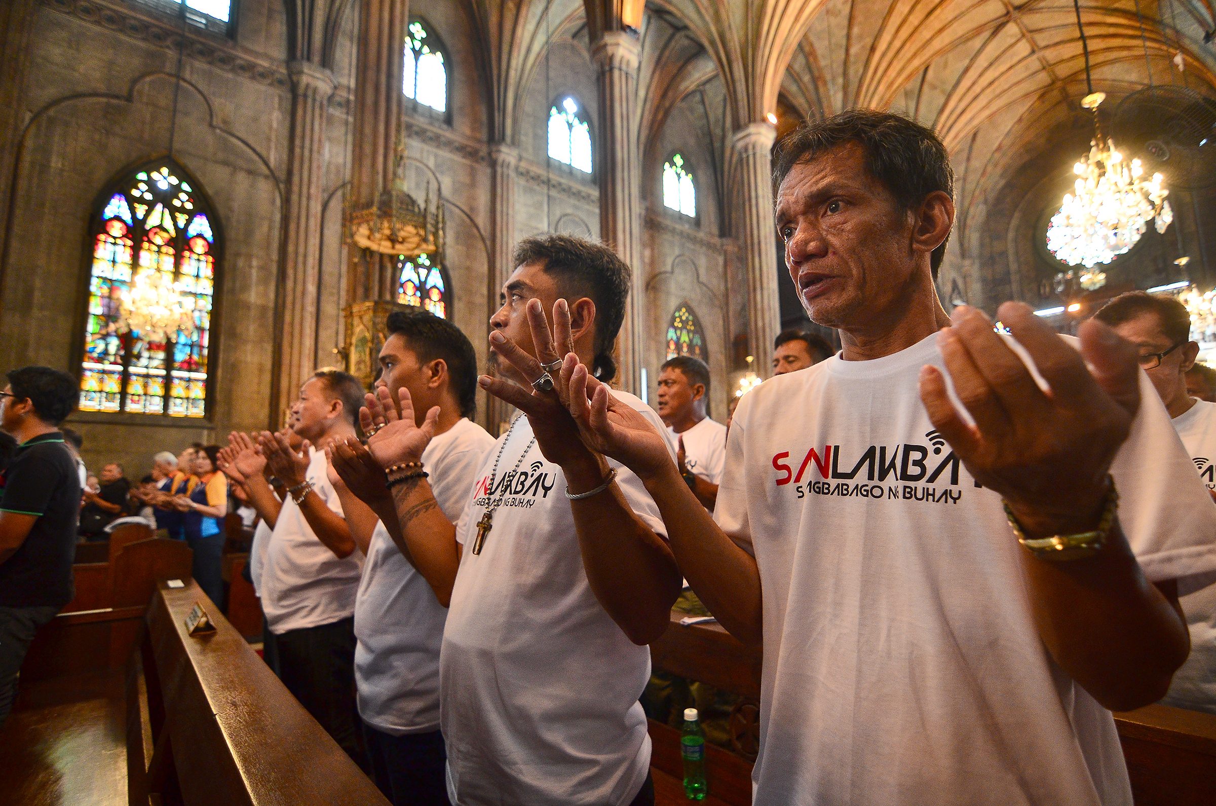 LORD'S PRAYER. Former drug dependents raise their hands as they sing the Lord's Prayer. Photo by Maria Tan  